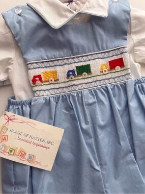 House of Hatten Smocked Blue & White Baby Romper with Colorful Truck Motif